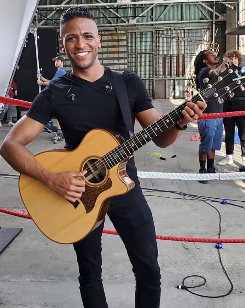 Alex holding a guitar